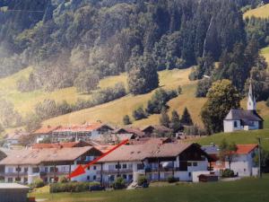 a village with houses and a hill with a church at Ferienwohnung Bergblume in Bolsterlang
