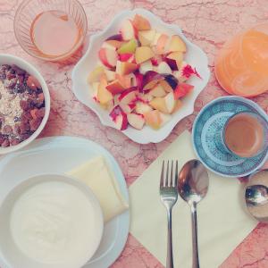 a table with plates of food and a bowl of fruit at Riad Idrissy in Fez