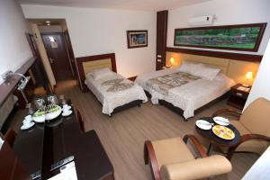 a hotel room with two beds and a table at Mersin Oteli in Mersin