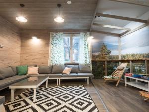 a living room with a couch and a large window at Eurohostel in Helsinki