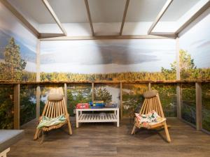 two chairs and a table on a balcony with a mural at Eurohostel in Helsinki