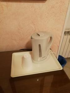a white coffee maker sitting on top of a table at Casa Zavatti in Rome