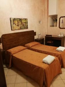 a room with three beds and a table with a table at Casa Zavatti in Rome