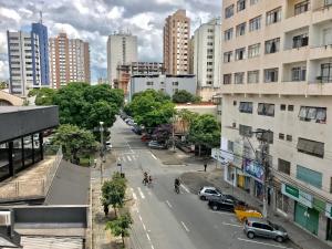 a view of a city street with cars and buildings at VA Apart Hotel Savassi in Divinópolis