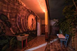 a hallway with a wall with a painting on it at VagaMundo Hostel Carhue in Carhué