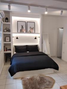 a bedroom with a large black bed with a furry rug at Super Stylish Apartments in Syntagma Square! in Athens