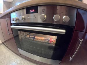 a toaster oven with its door open in a kitchen at Bonsai-Apartment II in Bad Pyrmont