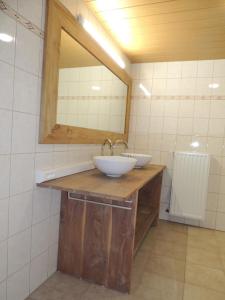 a bathroom with two sinks and a mirror at Vakantiehuis " Te Lande " in Torhout