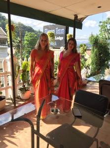 two women standing in front of a table at Days Inn in Kandy