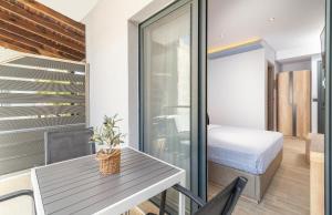 a small apartment with a bedroom and a table and a bed at Oasis in Sarti