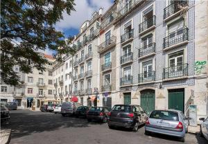 uma rua com carros estacionados em frente aos edifícios em Sleeping to the sound of Fado em Lisboa