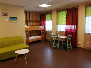 a room with a bed and a table and chairs at Everest Kivioli Hostel in Kiviõli