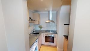 a small kitchen with a sink and a stove at Little Bury Barn in Bury Saint Edmunds