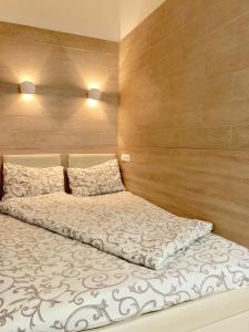 1 dormitorio con 1 cama grande y paredes de madera en Невелика Smart квартира в центрі для пари en Leópolis