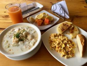 a table with a bowl of soup and a plate of food at Hotel Castillo Resort in San Gil