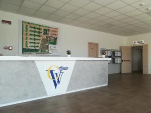 a reception desk in a building with a sign on the wall at Camping Verona Village in Verona