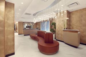 a lobby with a waiting room with chairs and a counter at Artezen Hotel in New York