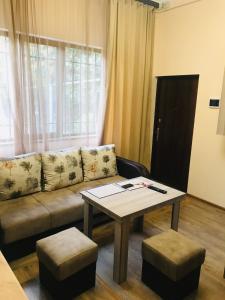 a living room with a couch and a table at Guest house Abovyan street in Yerevan