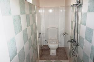 a small bathroom with a toilet and a shower at A&A Homestay in Seeduwa +25 photos