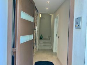 a hallway with a door leading to a hallway with stairs at Apartamentos Can Quim in L'Escala +38 photos