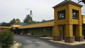 a building with a clock tower in a parking lot at Days Inn by Wyndham Attalla in Attalla