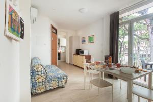 a living room with a table and a chair at Hotel residence Jamaica in Milano Marittima