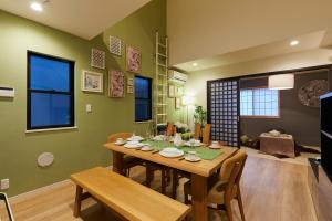 a dining room with a table and a living room at Asakusa Skytree Luxury House in Tokyo