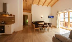 a kitchen and dining room with a table and chairs at Dürnberggut in Sankt Martin bei Lofer