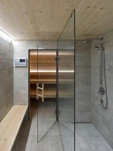 a shower with a glass door in a bathroom at Försterhaus Mellau in Mellau