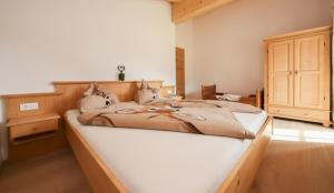 a bedroom with a large bed in a room at Dürnberggut in Sankt Martin bei Lofer
