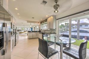 a kitchen with a glass table and chairs at LOCATION LOCATION LOCATION in Pompano Beach