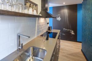 a kitchen with a sink and a counter top at Habitat Apartments Cool Jazz in Barcelona