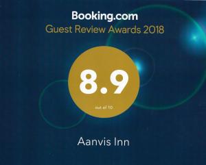 a sign that says guest review awards with a yellow circle at Aanvis inn in Ooty