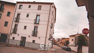 a white building on a street with a stop sign at Hotel Ristorante Cigno in Latisana