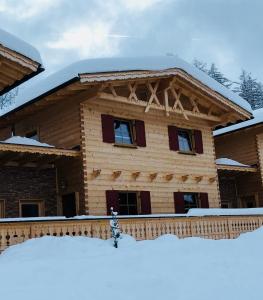 a log house with snow on the porch at Obern 41 in Leutasch