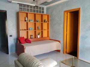 a bedroom with a bed and a couch in a room at Webus Apartments in Praia a Mare