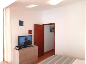 a living room with a television on a dresser at The Terrace in Vernazza