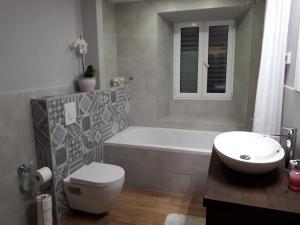 a bathroom with a tub and a toilet and a sink at Guesthouse Juric in Skradin +46 photos