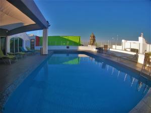 a large swimming pool on top of a building at Roma Guadalajara in downtown in Guadalajara