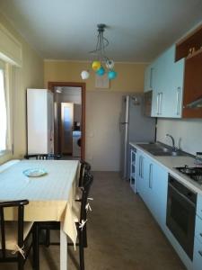 a kitchen and dining room with a table and chairs at A casa di Bruna in Martella +5 photos