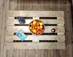 a basket of fruit on a wooden wall at Good Stay Sofia Apartments in Sofia