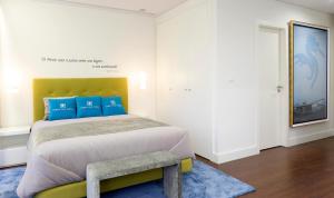 a bedroom with a large bed with blue pillows at Porto Old Town – Tourism Apartments in Porto