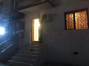 a stairway with a door and a window at Pearl apartment in Kutaisi in Kutaisi