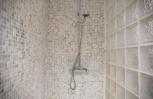 a shower with a shower head in a bathroom at Hiker's TownHouse in Sóller