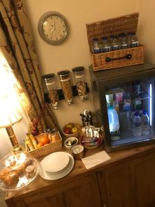 a clock on a wall above a table with food at Durham Ox Ilkeston in Derby