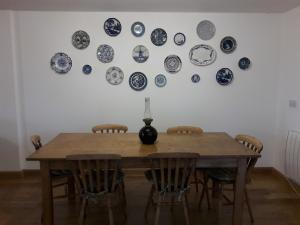 a dining room table with blue and white plates on the wall at The Barn Annexe, Cefn-Yr-Allt in Crickadarn