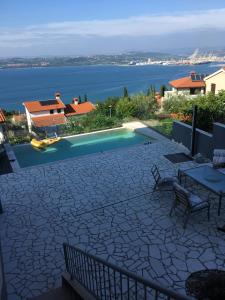 a patio with a pool and a view of the water at Liams Mansion in Koper
