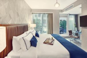a hotel room with a large bed and a desk at Artezen Hotel in New York