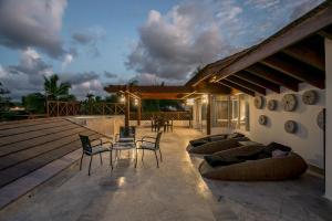 a patio with chairs and a table on a deck at Balcones Beach Penthouse in Las Terrenas