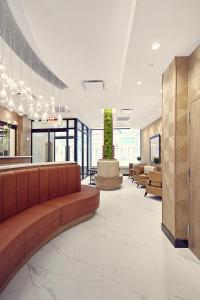 a lobby with couches and tables in a building at Artezen Hotel in New York
